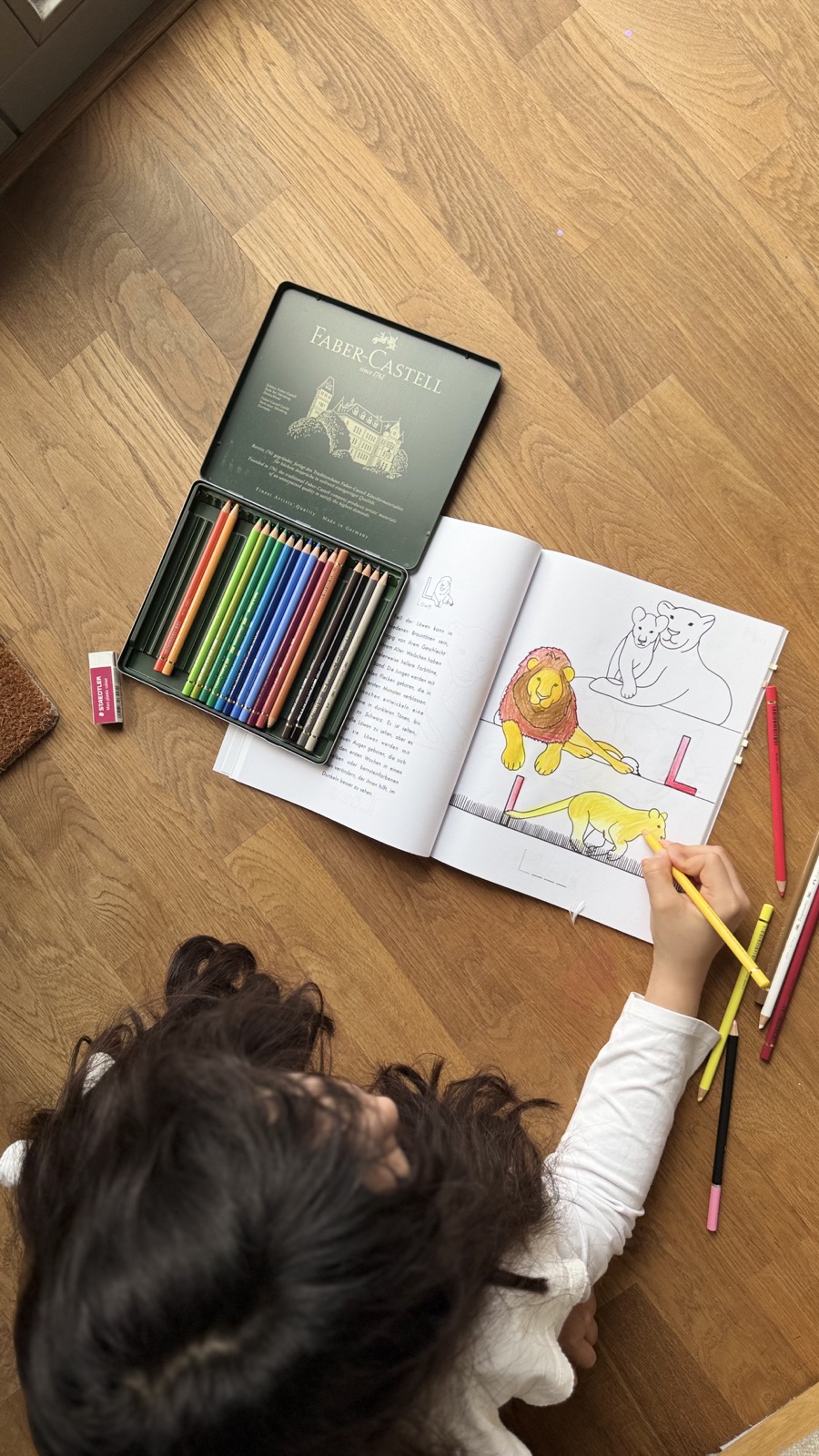 A child coloring a multilingual book at home